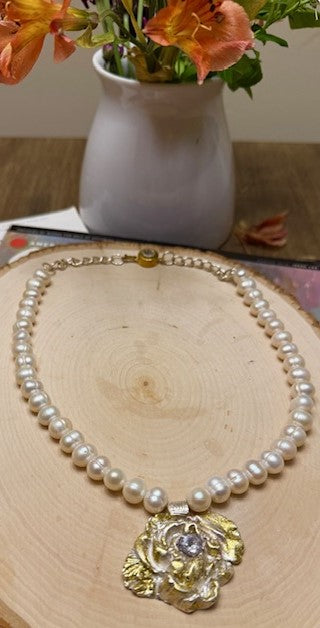 imeless beauty.
Celebrate artistry and tradition with this exquisite flower necklace, meticulously handcrafted from .999 pure fine silver and adorned with radiant 24K gold sheet using the ancient Korean Keum-Boo technique. This centuries-old gilding process bonds pure gold to silver, creating a warm, luminous contrast that will never fade.
